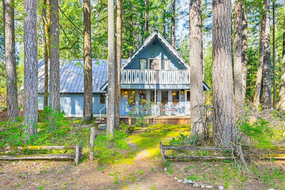 The A-frame house tucked among tall evergreens